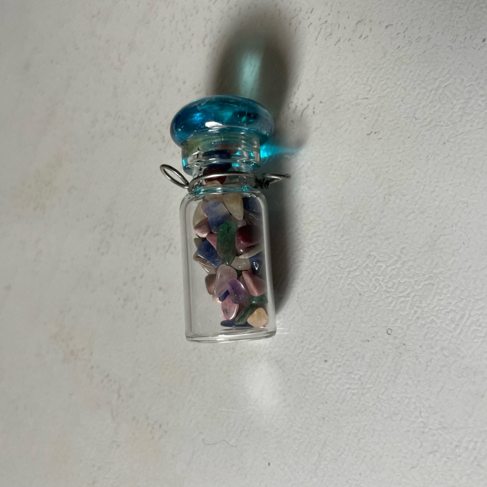 Blue and multicoloured stones in bottle necklace charm (1998)